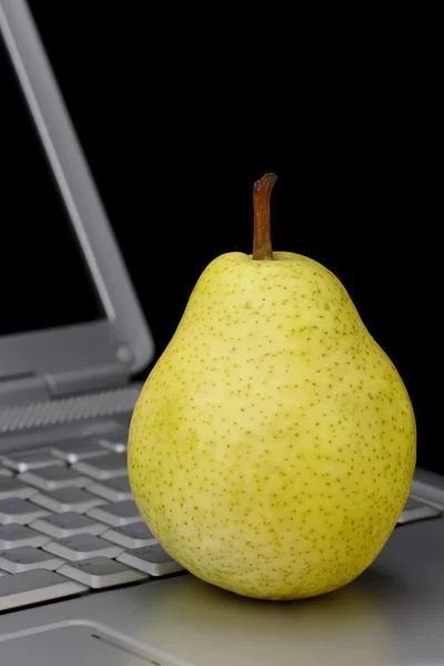 Pear and laptop. — Stock Photo, Image