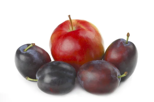 Plums and apple. — Stock Photo, Image