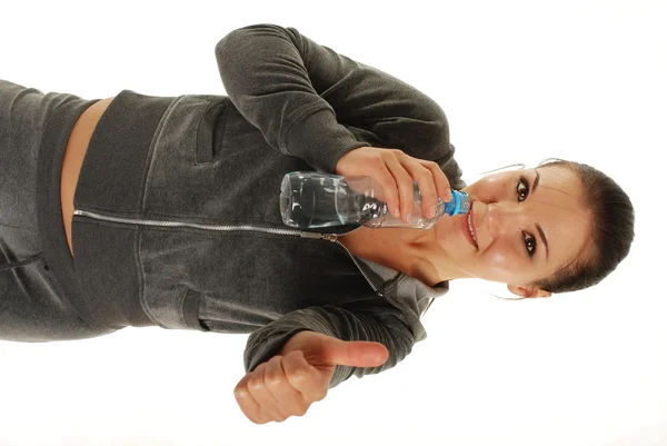 Attractive brunette thirsty woman with bottle of water — Stock Photo, Image