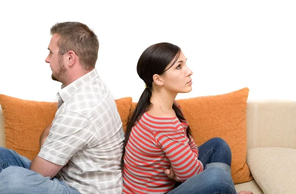 Angry couple sitting on sofa — Stock fotografie