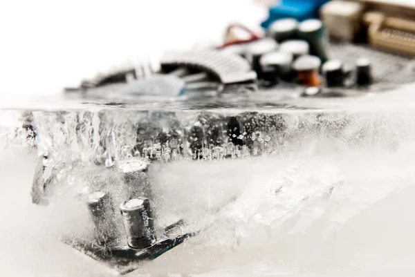 Frozen computer part in ice cube — Stock Photo, Image