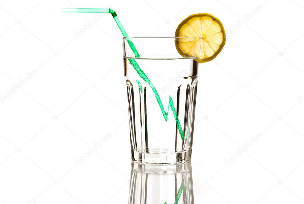 Glass of water with green straw