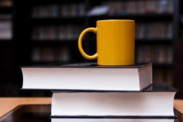 Mok van koffie op de stapel boeken — Stockfoto