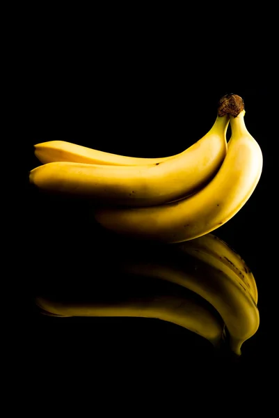 Ripe bananas on black — Stock Photo, Image