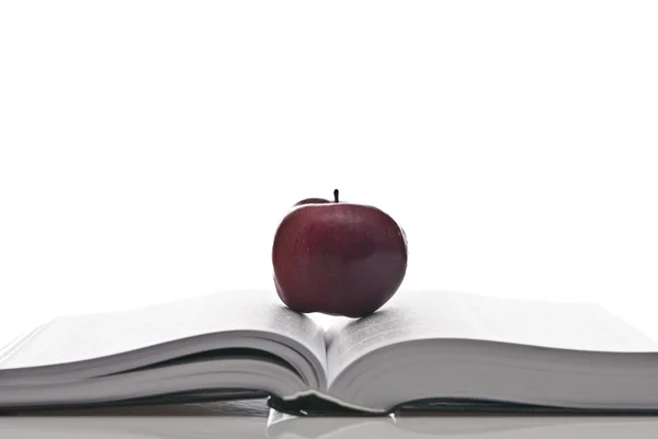 Opened hefty book and fresh red apple — Stock Photo, Image
