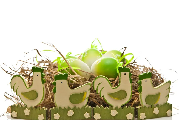 Easter eggs in nest and chickens — Stock Photo, Image
