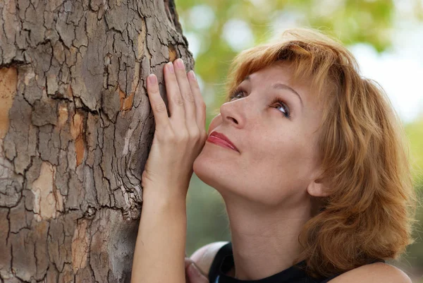 Schöne Frau in der Nähe von Baum — Stockfoto