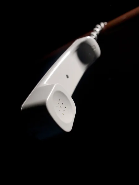 Telephone receiver hanging on the cord — Stock Photo, Image