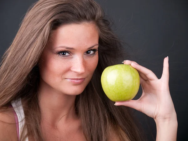 Chica con una manzana verde Fotos de stock