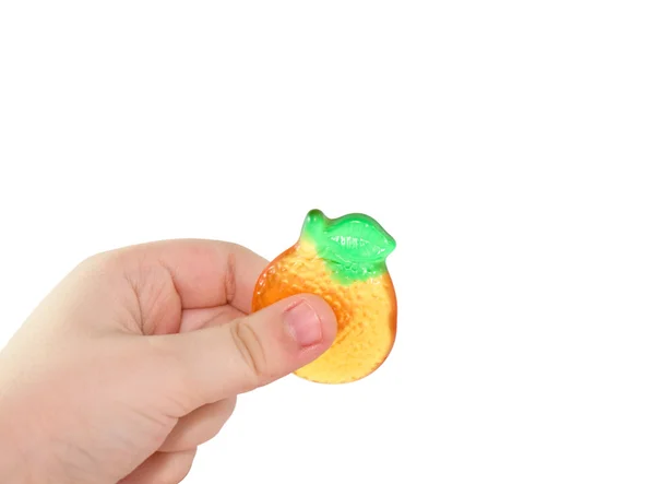 Children's hand holds fruit candy — Stock Photo, Image