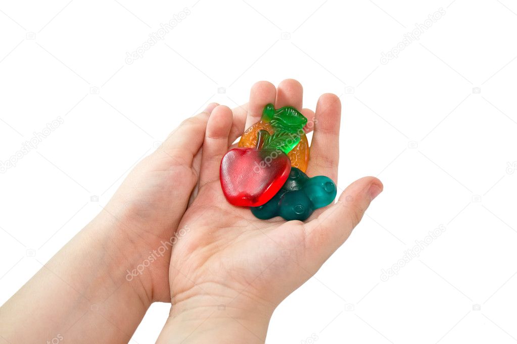 Children's hands holds fruit candy