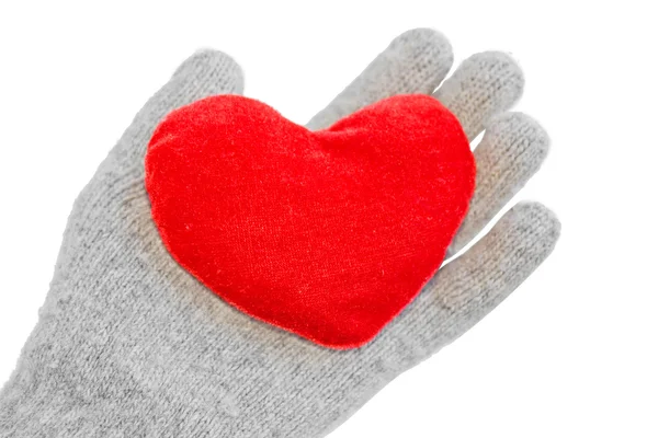 Hand in a glove holds heart — Stock Photo, Image