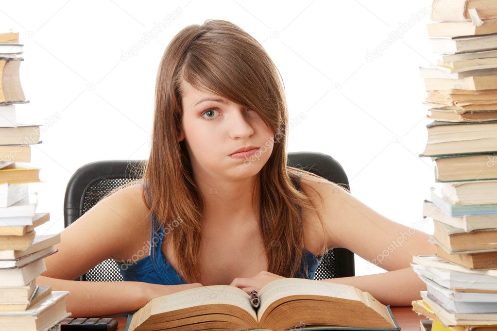 Girl studying at the desk being tired