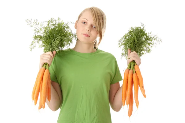 Pretty girl with ripe carrots — Stock Photo, Image