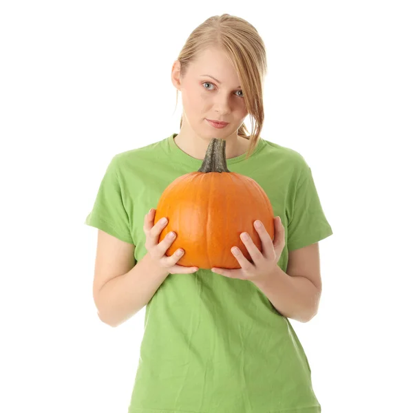 Young woman holding orange pumpkin — Stock Photo, Image