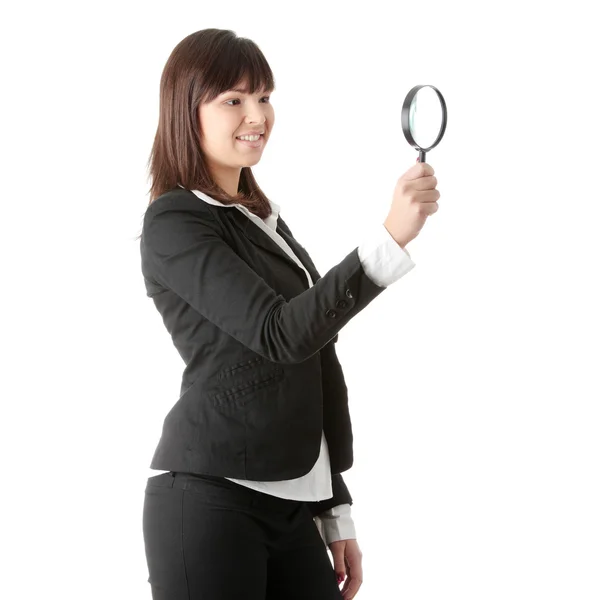 Woman looking into a magniying glass — Stock Photo, Image