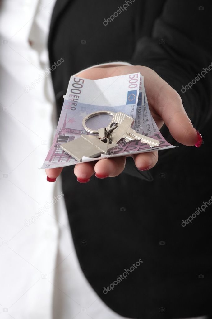 Beautiful woman holding keys and moneys