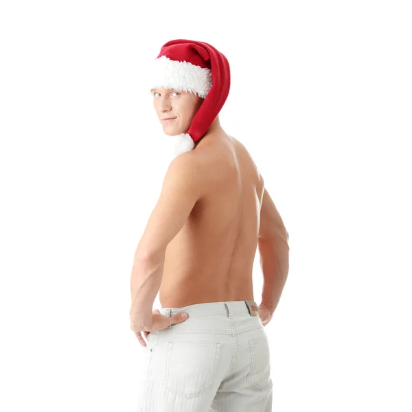 Sexy gespierde man dragen van een hoed santa claus — Stockfoto