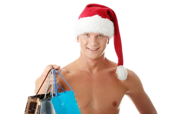 Sexy muscular sem camisa homem no Papai Noel chapéu — Fotografia de Stock