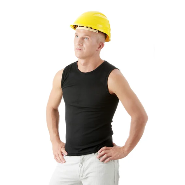 Joven constructor guapo en casco amarillo . — Foto de Stock