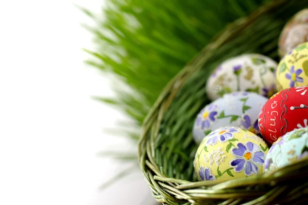 Easter egg in wicker basket — Stock Photo, Image