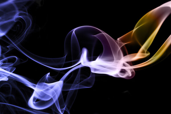 Colored incense smoke abstract on black, horizontal