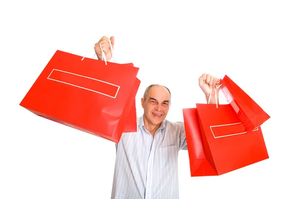 Człowiek uśmiech przyniesie wiele torby papierowe — Zdjęcie stockowe