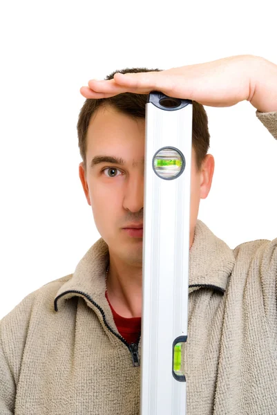 Man looking to level tool — Stock Photo, Image