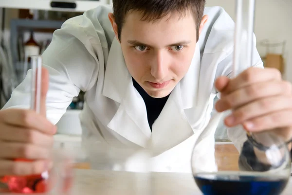 Человек в лаборатории с фляжкой — стоковое фото