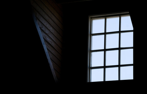 A window in the loft of an old house.