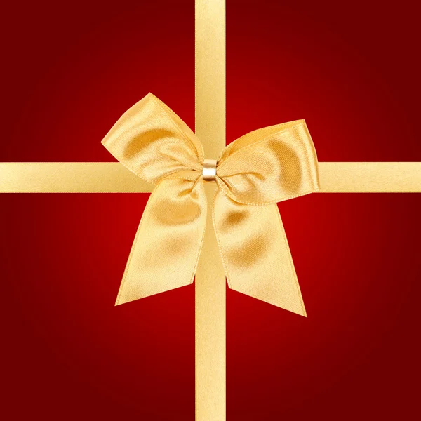 Goldene Weihnachtsschleife auf roter Karte — Stockfoto