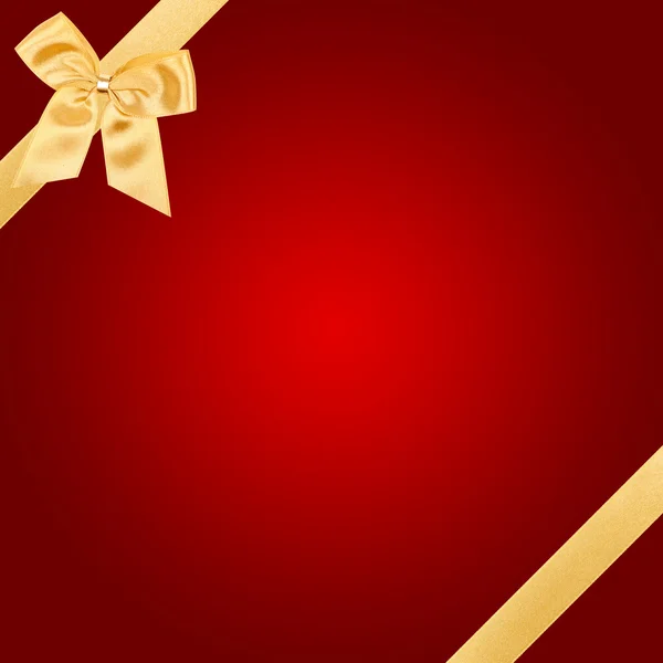 Gouden Kerstmis strik op rode kaart Stockfoto