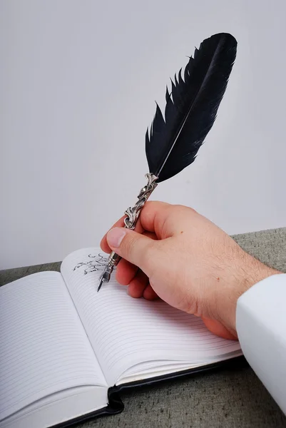 Male hand writing with feather — Stock Photo, Image