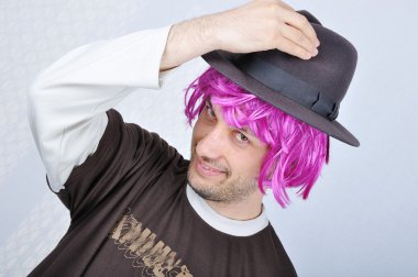 Young funny man with wig and hat clipart