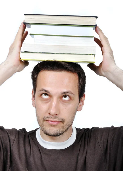 Joven hombre sosteniendo libros con expresión en su — Foto de Stock