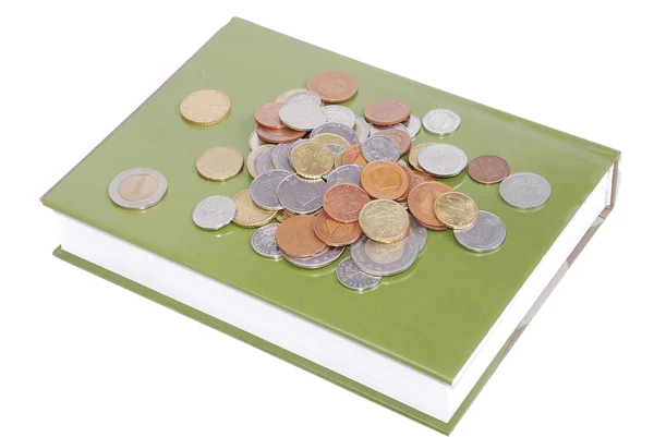 Monedas en libro — Foto de Stock