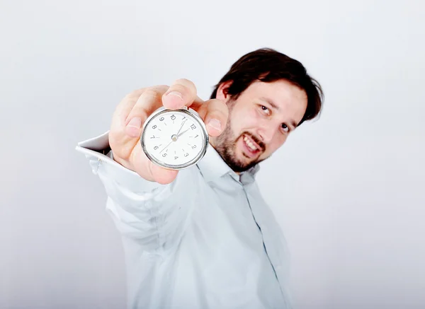 Young man with clock or watch in his hand — Stock Photo, Image