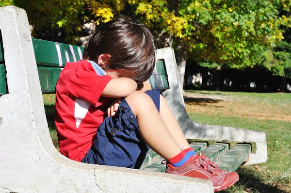 Triste niño en el parque, al aire libre, verano t —  Fotos de Stock