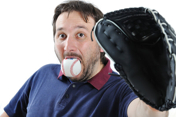 Young man with baseball ball in mouth
