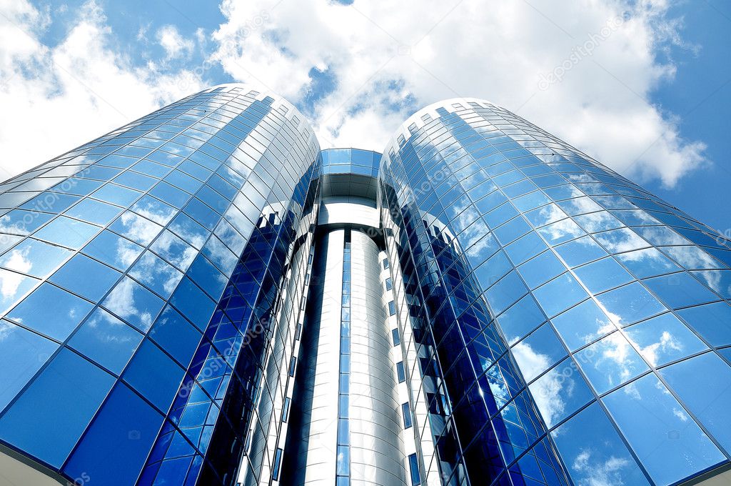 Two glass towers against the sky