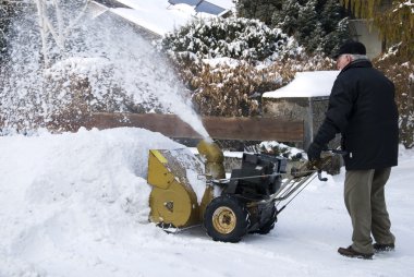 Senior man with snowblower clipart