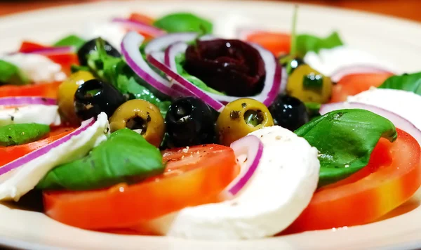 Caprese salad with olives — Stock Photo, Image