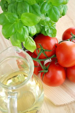 Tomatoes with basil and oil clipart