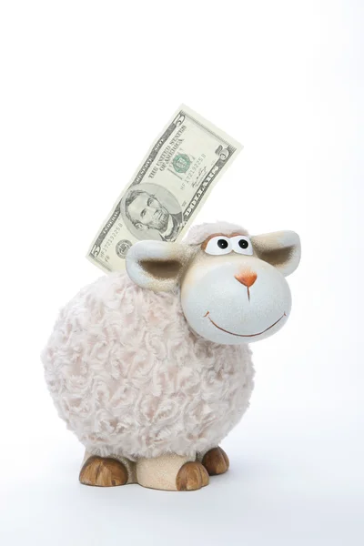 Banco de monedas de oveja con dólares americanos —  Fotos de Stock
