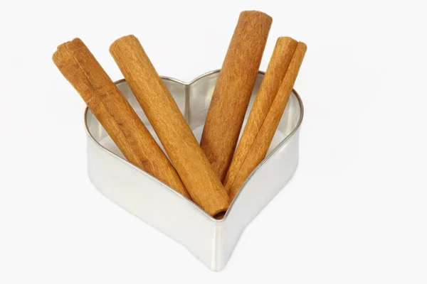 Cinnamon and cookie cutter — Stock Photo, Image