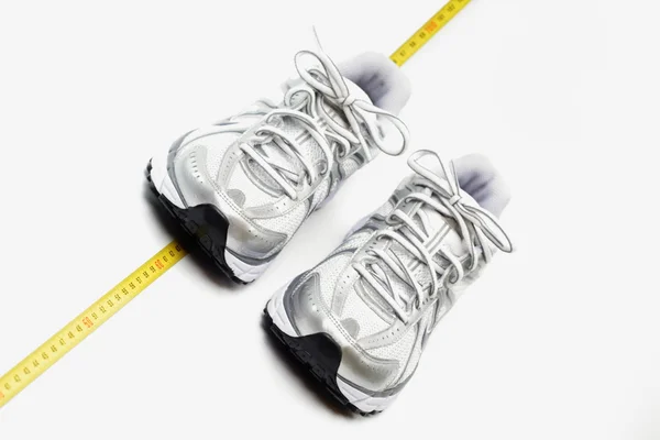 Fitness concept trainers and centimeter — Stock Photo, Image