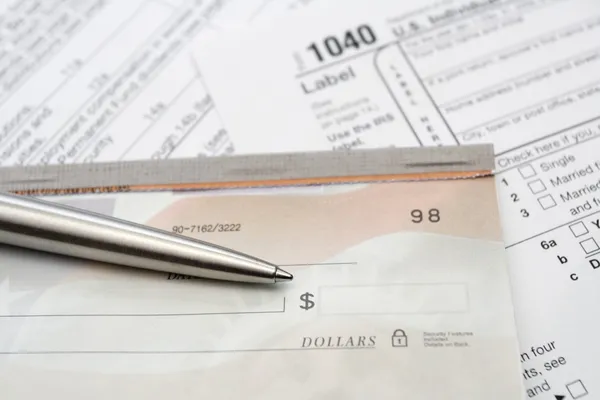 Check and silver pen with tax form — Stock Photo, Image