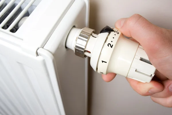 stock image Radiator adjustment by man.