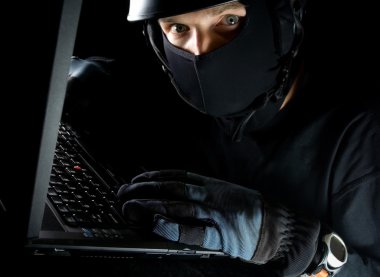 Computer theft on laptop at night clipart