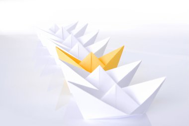 Yellow paper boat in queue clipart